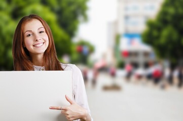 Happy young student woman holding signboard