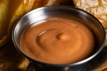 Close-up of Creamy Orange Dipping Sauce in Metal Ramekin