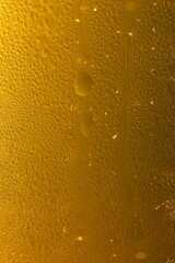 Extreme Close-up of Cold Golden Beer Foam and Condensation
