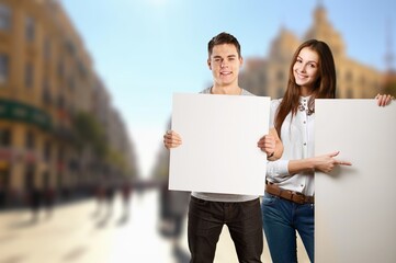 Happy young student woman holding signboard