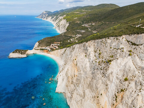 Aerial view of the dramatic white cliffs meeting the turquoise Ionian Sea at Porto Katsiki beach, a symphony of nature's artistry, Lefkada, Lefkada, Greece.
