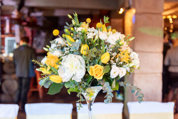 Elegant Yellow and White Floral Arrangement in a Wedding Reception Setting