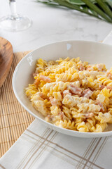 Fusilli pasta with creamy carbonara sauce and bacon