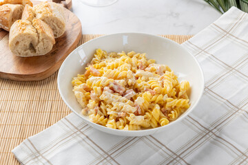Fusilli pasta carbonara with bacon and cheese sauce