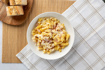 Pasta fusilli carbonara with bacon and creamy sauce