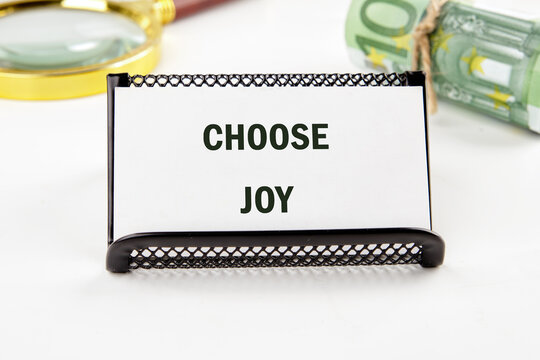 A motivational card reads Choose Joy, with a magnifying glass and Euros nearby. The composition suggests exploring financial freedom with positivity and reflection