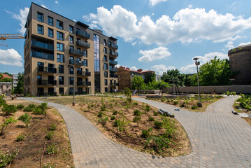Fototapeta premium Modern Apartment Building With Outdoor Playground and Landscaped Garden in Urban Setting