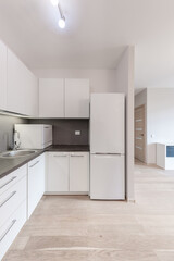 Modern Home Minimalist Kitchen Design With White Cabinets and Black Countertop