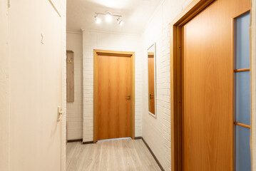 Modern Apartment Hallway with Wooden Door and White Brick Wall