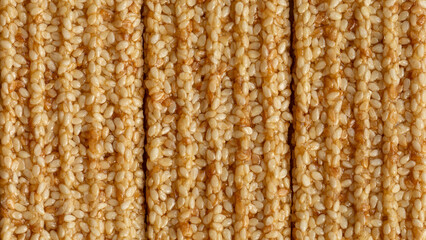 Top surface of a sweet sesame seeds candy bars. Background texture. Flat lay.