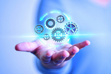 Hand holding glowing gears in a circle, symbolizing technology and innovation