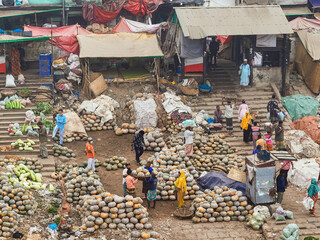 Dhaka, Bangladesh - 18 February 2025: Aerial view of bustling marketplace at Dhaka's riverfront, where vibrant colors and textures intermingle amidst the rhythmic activity of vendors and buyers.
