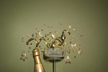 Party fashion background with champagne glass and bottle and golden confetti stars. Christmas,...
