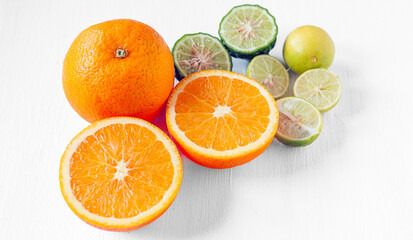 Citrus fruit of Halved orange fruit, slices lemon or lime fruit and bergamot fruit on white background,
