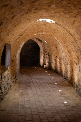 Fototapeta premium Historic underground tunnel with arched brick ceiling 