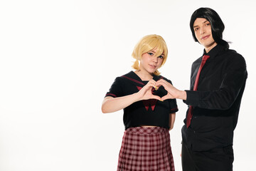Youthful anime duo sharing a heartfelt moment with intertwined fingers