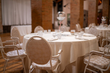 Elegant Round Dining Table Set for Formal Event Celebration with Chairs Decorated in White Fabric Ready for Guests Arrival Dinner Party Occasion