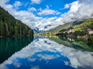 Idyllic and tranquil view of Lago di Santa Caterina, a mountain lake near Auronzo di Cadore with scenic reflections in calm water. Dolomites, Italy
