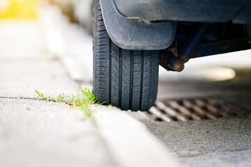 Vehicle improperly parked on the curb with one wheel elevated, careless driving and traffic rules...