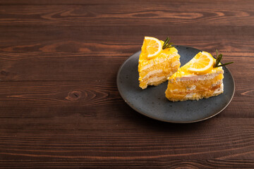 Lemon cake on brown wooden, side view, copy space
