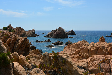 Landscape of Costa Paradiso, Sardinia, Italy. A picturesque coastline with red cliffs, hidden coves, and crystal-clear waters, perfect for nature lovers and those seeking tranquility