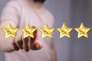 Man pointing to five golden stars representing rating, review, feedback, quality, and customer...