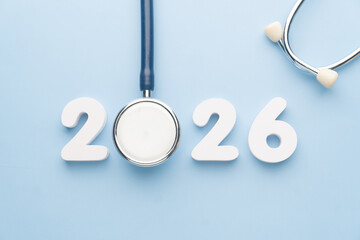 Stethoscope with 2026 number on blue background. Happy New Year for health care and medical banner calendar cover. Creative idea for new trend in medicine treatment and diagnosis concept.