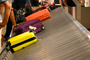 Suitcases moving on an airport baggage conveyor belt during luggage claim. Travelers wait to pick up their bags after a flight. Luggage, suitcase on the conveyor belt in an arrivals lounge © PaulSat