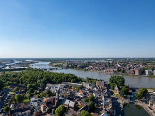 Klein-Willebroek, Willebroek, Antwerp, Belgium, 13th of May, 2025, This stunning aerial view shows a picturesque town by a winding river, beautifully surrounded by lush greenery