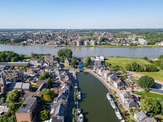 Fototapeta premium Klein-Willebroek, Willebroek, Antwerp, Belgium, 13th of May, 2025, A stunning aerial view that showcases a picturesque town gracefully positioned along a serene waterway