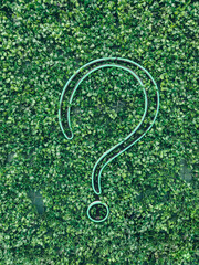 A question mark (?) with grass background, eco text effect. Ecological question. Advice and question.