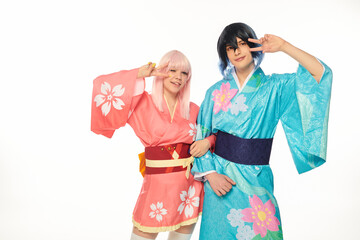 Obraz premium Cosplayers dressed in kimonos strike peaceful poses with happiness