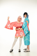 Youthful exuberance a pair strikes a pose in anime inspired kimonos