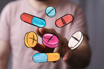 Image of hand interacting with colorful pills and capsules. Perfect for healthcare, medicine, pharmacy, and drug concepts.