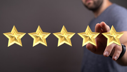 A person with a hand reaching for a cluster of five golden stars, representing feedback,...