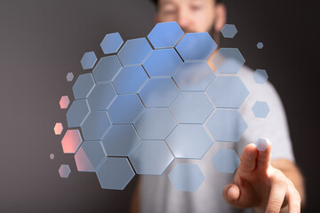 Abstract image of a man interacting with a futuristic hexagon network, ideal for technology, connection, and innovation concepts.