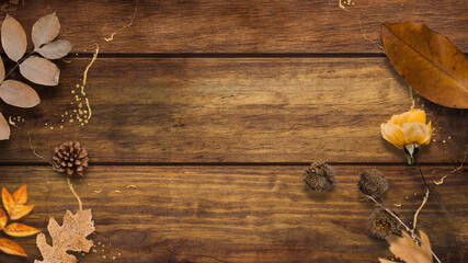 Autumn leaves on a vintage brown plank wood texture background