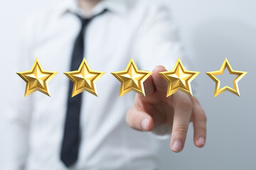 A business person is giving a rating of four stars out of five, using his finger to point. Concept of quality, customer experience and review.