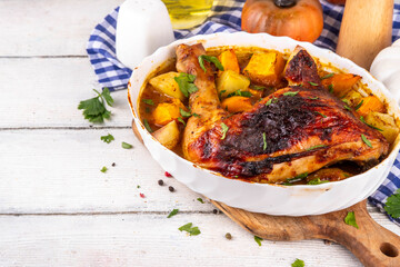 Roasted baked chicken quarter with pumpkin and potato stew