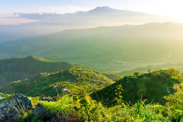 beautiful mountain sunset landcape with great magestic mountains and amazing slopes and canyons with evening clouds. Panorama of vulcano Etna in Sicily, Italy.