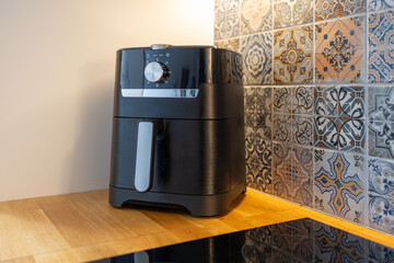 Air fryer machine in kitchen. Kitchen gadget, fast frying oil free. Healthful way to cook deep-fried food