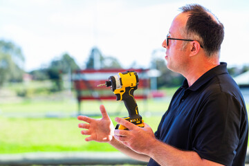 tool demonstrator talking about tools holding brushless impact driver