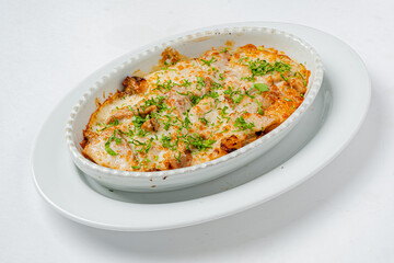 Savory layers of comforting goodness topped with melted cheese and vibrant green herbs