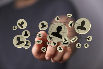 Person touching a digital network with abstract user icons, concept for technology, social networking, connection, and business communication.