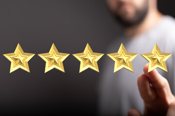 A person uses fingers to select golden stars, demonstrating quality and review. Represents a...