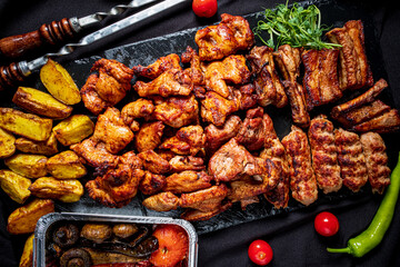 A vibrant spread of grilled meats, tender potatoes, and fresh herbs showcases culinary delight