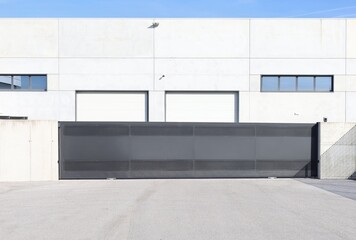 Long black sliding gate at the entrance of the industrial building. Background for copy space