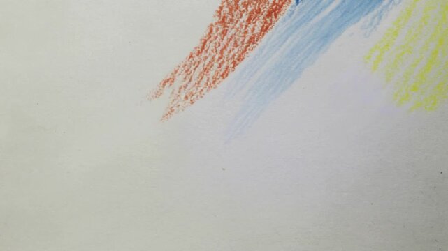 Three parallel crayon strokes in red blue and yellow on a textured white paper background drawing colorful.