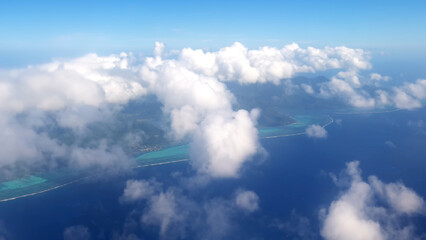 Fototapeta premium Luxury resort photo of Bora Bora tropical paradise islands with palm trees. Aerial perspective photography, coral reef, azure ocean, sky with clouds on horizon. French Polynesia. Pacific Ocean.