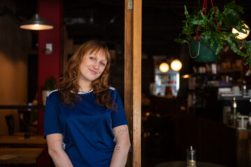 young barista outside an inner city cafe
